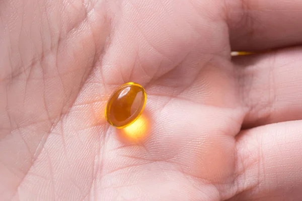 Lot of vitamins D3 capsules piles, in woman hands
