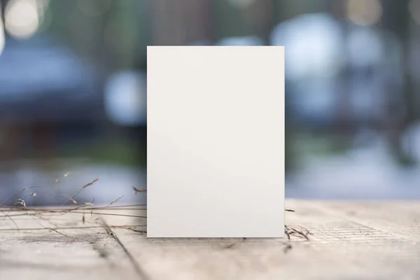 White blank paper board, frame, sheet on old wooden table, mock