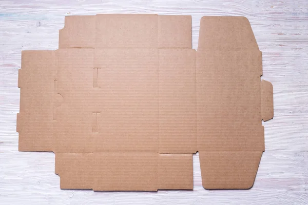 Flat Unfolded Brown Cardboard Box Wooden Background — Stock Photo, Image