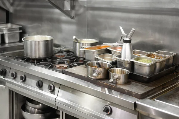 Stainless steel restaurant professional kitchen equipment and work surface. Royalty Free Stock Photos