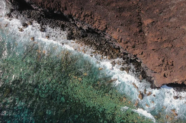 Αεροφωτογραφία κυμάτων που πέφτουν πάνω σε βραχώδεις ηφαιστειακές ακτές. Υψηλής ποιότητας φωτογραφία. — Φωτογραφία Αρχείου