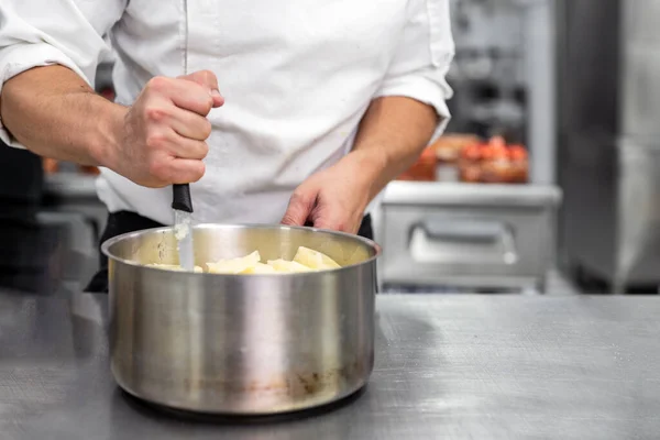 Unrecognizable Chef stirring in a pot in. — Stock Photo, Image