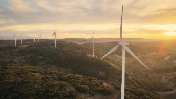 Amazing aerial view of wind turbines producing clean renewable energy, at a vibrant Sunset. — Stock Video