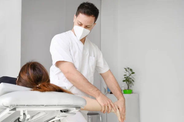 Erkek terapist, fizyoterapi kliniğindeki bir kadın hastaya omuz ağrısı için masaj yapıyor.. — Stok fotoğraf
