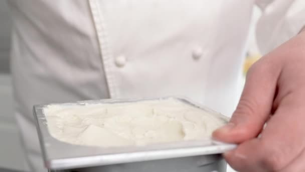 Close up of Chef scooping vanilla ice cream out of container — Stock Video