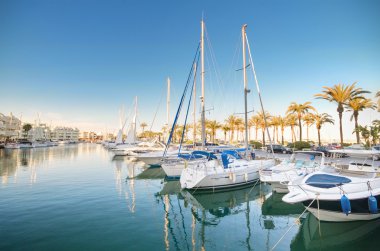 Scenic view of some Yachts in Marina port at dusk, in Benalmadena, Malaga, Spain. clipart