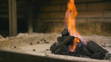 Yavaş çekimde yükselen alevlerle kömür yakarken, sıcak ve kırsal bir ortamda barbekü ya da şömine için parlayan közleri yakarken. Yüksek kaliteli FullHD görüntüler