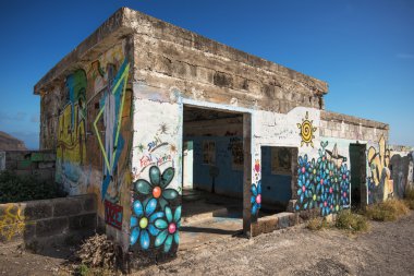 SANTA CRUZ DE TENERIFE, SPAIN - JANUARY 30: Painted graffiti on the wall of an abandoned building on January 30, 2016 in mirador de las Teresitas, Santa Cruz de Tenerife, Spain.