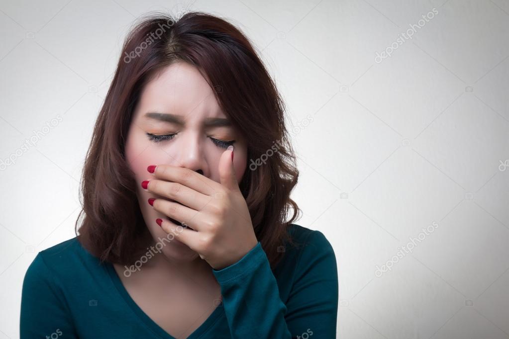 woman yawning on white background