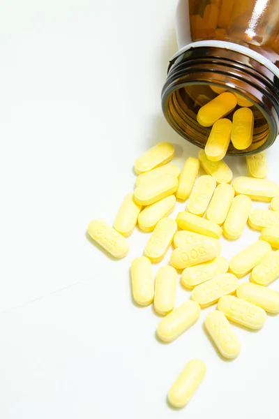 Yellow pills on white background — Stock Photo, Image