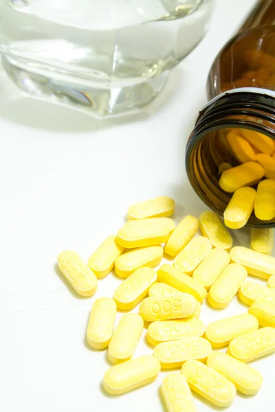 Yellow pills on white background — Stock Photo, Image