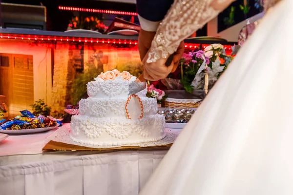 bride and groom cut wedding cake close