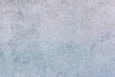 Arka plan, tüm çerçevede gri kumlu alçı dokusu. Yatay çerçeve.