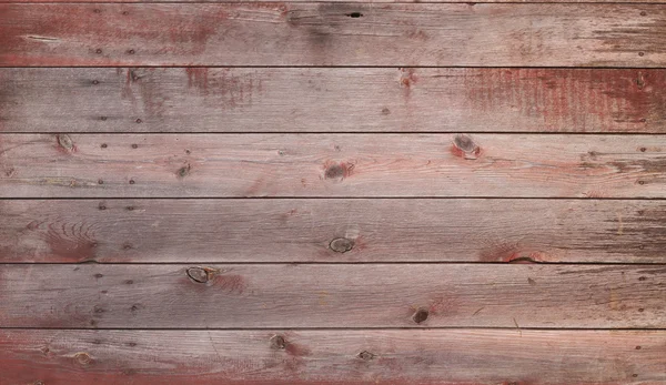 Old red and gray wooden barn door with nails — Stock Photo, Image