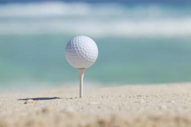 Kum Beach ile okyanus dalgaları arkasında tee Golf topu
