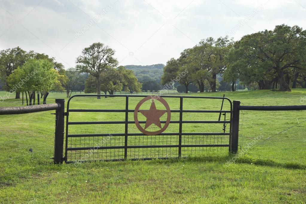 Ranch gate with pasture and trees in the Texas Hill Country