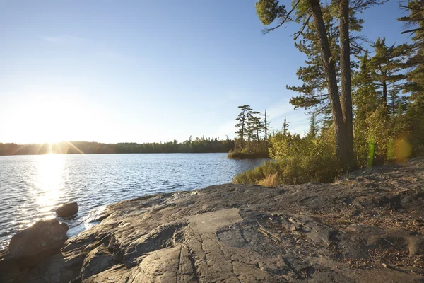 Sunset on lake with rocky shore in northern Minnesota — Stock Photo, Image