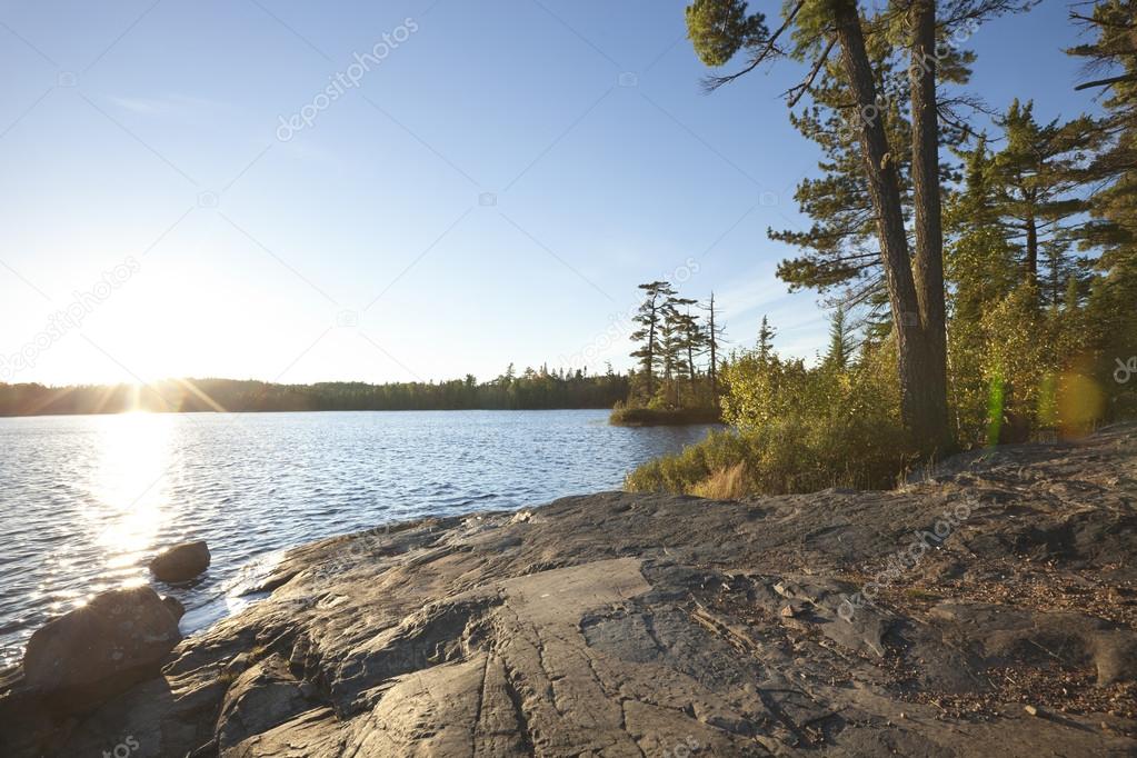 Sunset on lake with rocky shore in northern Minnesota