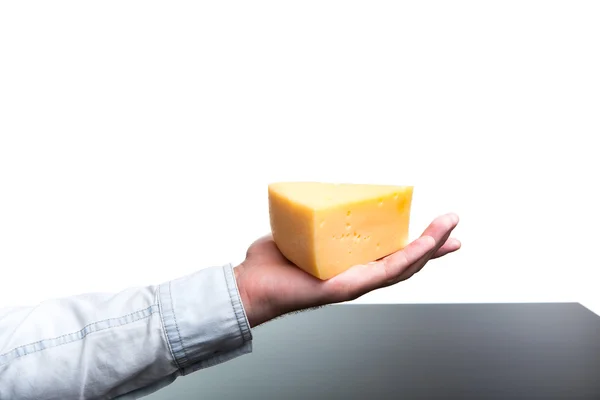 Man holds in his hand a piece of cheese. — Stock Photo, Image