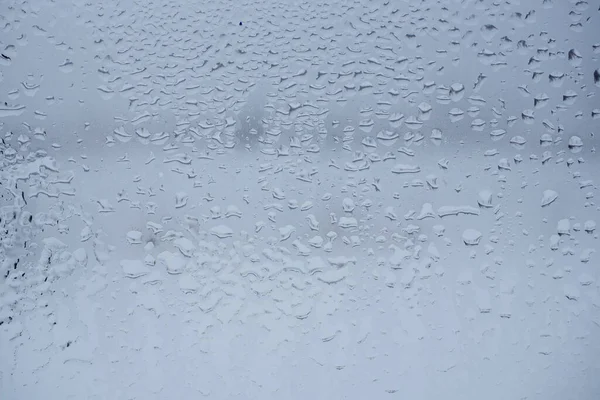 Wet glass texture. Raindrops on the window. Abstract background. Template.