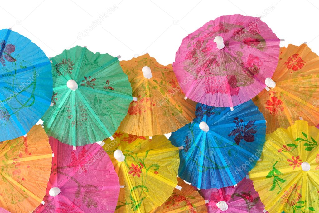 Colorful paper cocktail umbrellas close-up on a white