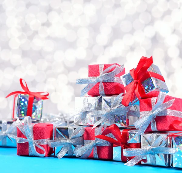 Silver and red gifts on a bokeh background — Stock Photo, Image