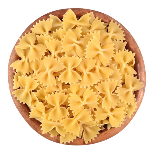 Italian pasta farfalle in a wooden bowl on a white — Stock Photo, Image