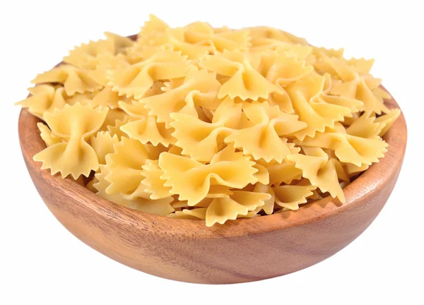 Pasta farfalle italiana in una ciotola di legno su un bianco — Foto Stock