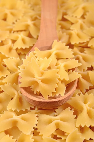 Italian pasta farfalle in a spoon — Stock Photo, Image