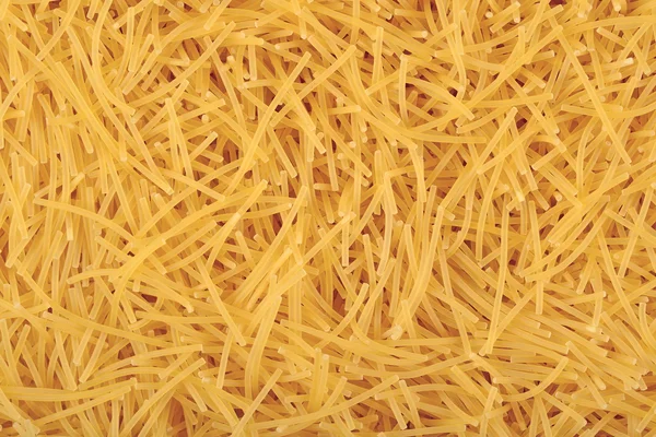 Uncooked italian pasta as background texture — Stock Photo, Image