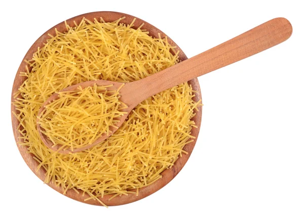 Uncooked italian pasta in a wooden bowl on a white — Stock Photo, Image