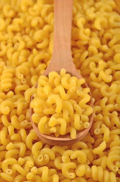 Uncooked italian pasta in a spoon — Stock Photo, Image