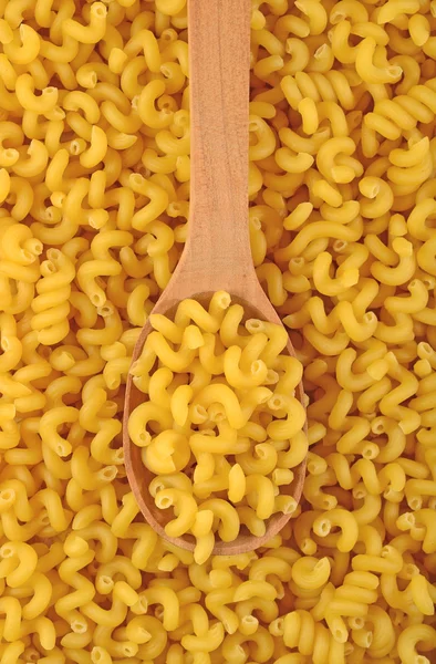 Uncooked italian pasta in a spoon — Stock Photo, Image