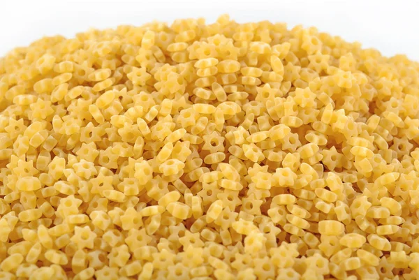 Heap of uncooked italian pasta stars on a white — Stock Photo, Image
