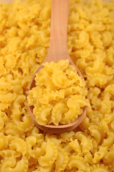 Uncooked italian pasta in a spoon — Stock Photo, Image