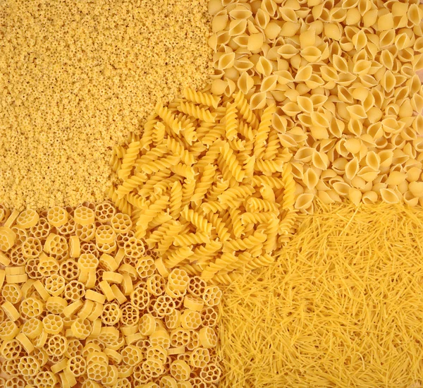 Assortment of uncooked Italian pasta as background — Stock Photo, Image