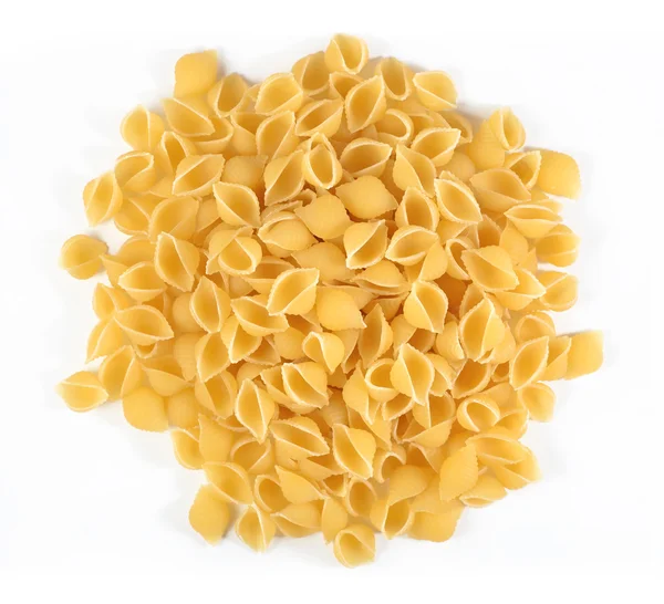 Heap of uncooked italian pasta shells on a white — Stock Photo, Image