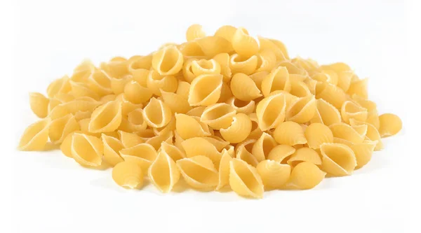 Heap of uncooked italian pasta shells on a white — Stock Photo, Image