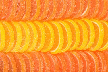 Orange and lemon candy slices as background clipart