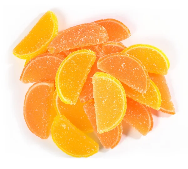 Heap of orange and lemon candy slices on a white — Stock Photo, Image