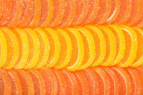 橙和柠檬糖片作为背景 图库图片