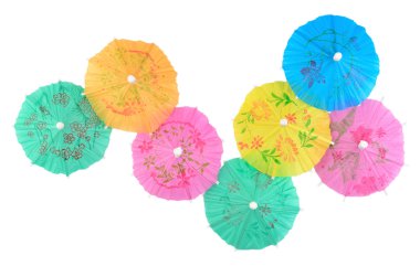 Colorful paper cocktail umbrellas close-up on a white  clipart