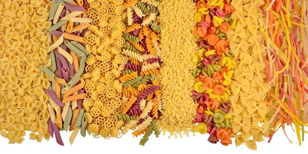 Assortment of colored uncooked italian pasta on a white — Stock Photo, Image
