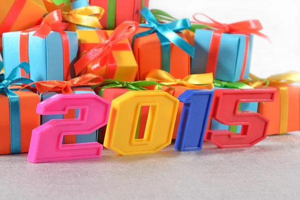 2015 year colorful figures on the background of gifts — Stock Photo, Image