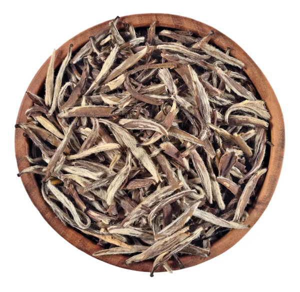 Green tea leaves in a wooden bowl on a white — Stock Photo, Image