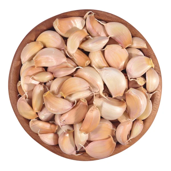 Garlic cloves in a wooden bowl on a white — Stock Photo, Image