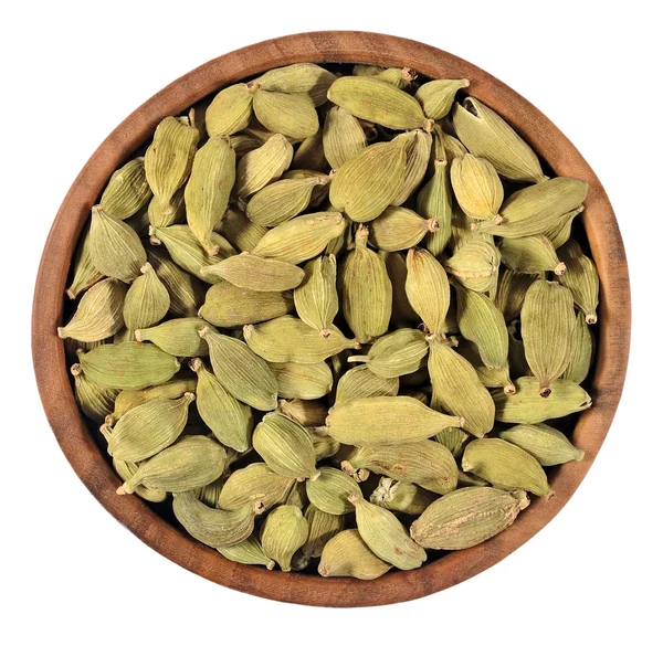 Cardamom seeds in a wooden bowl on a white — Stock Photo, Image