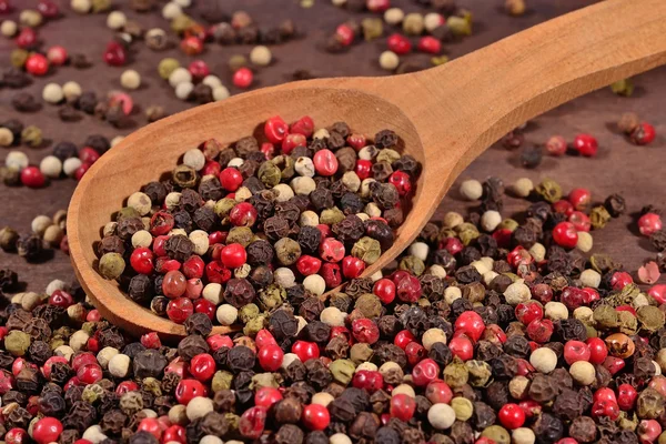 Colored pepper in a spoon — Stock Photo, Image