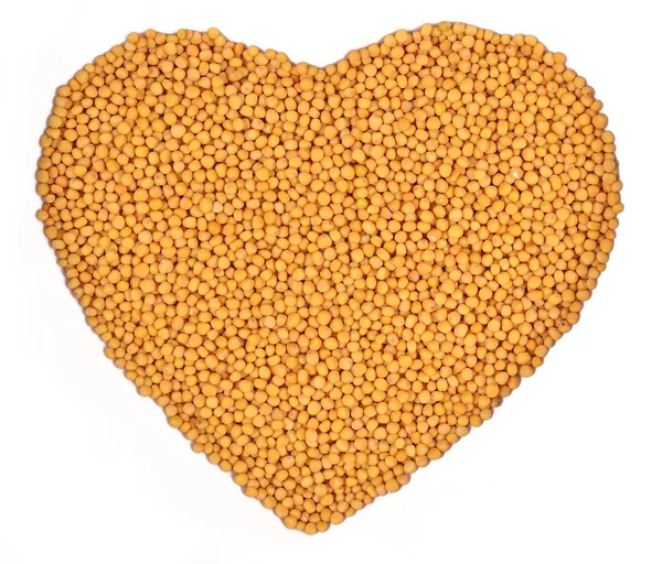 White mustard in the form of heart on a white — Stock Photo, Image