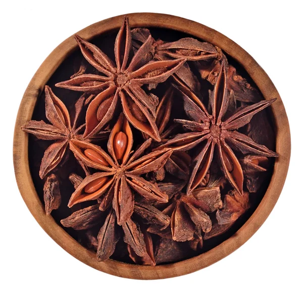 Star anise in a wooden bowl on a white — Stock Photo, Image